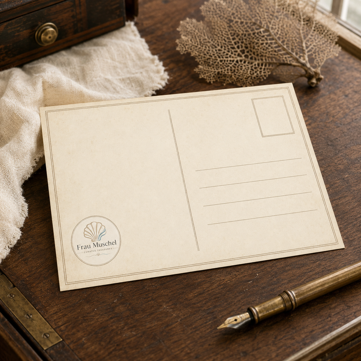 Matching horizontal postcard back with address lines, an empty stamp field, vintage maritime details and the round Frau Muschel logo.