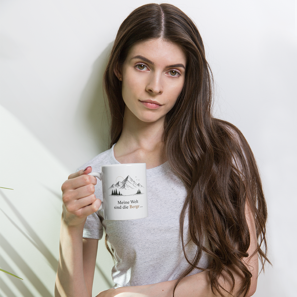 Woman holding a white ceramic mug with a mountains and sea design by Frau Muschel